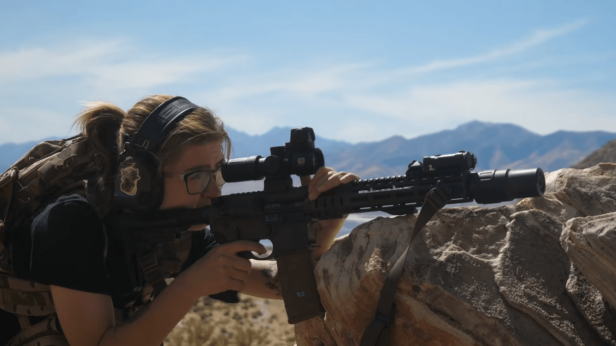 Shooter aiming 5.56 AR-15 carbine