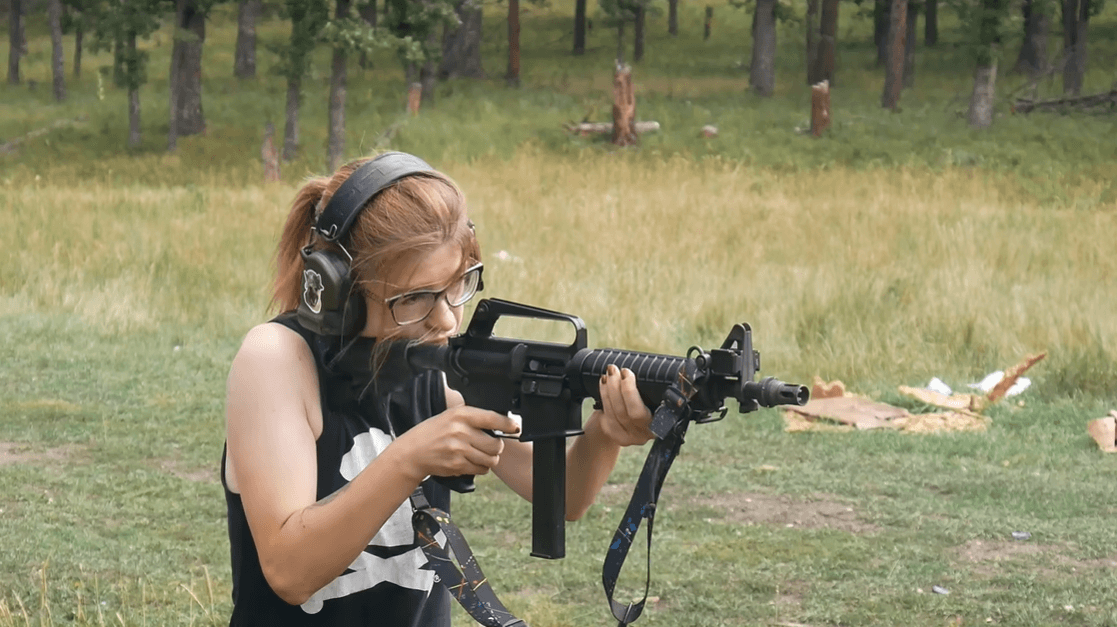Shooter firing H&R 635 9mm carbine