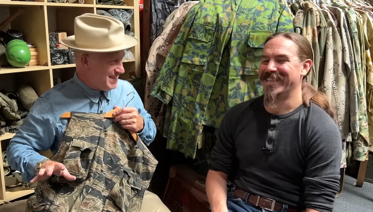 Ian McCollum holding tiger stripe vest